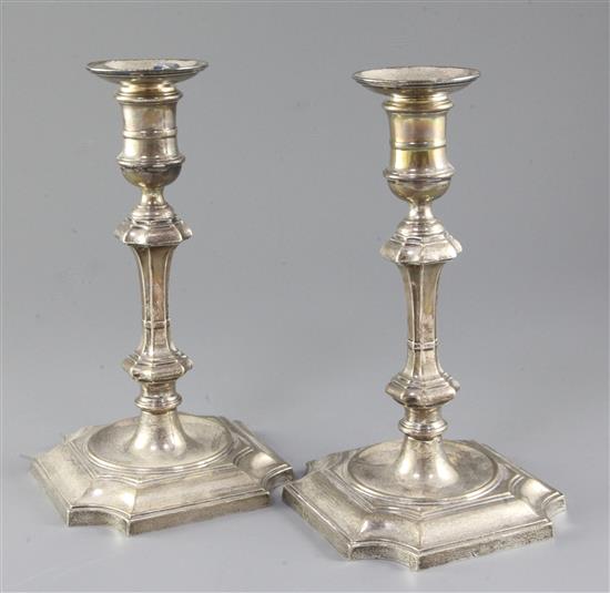 A pair of 1930s 18th century style silver candlesticks, weighted.